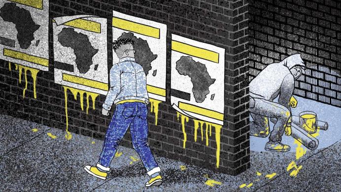 Posters of Africa being put up by a man in a hoodie, hiding in the shadows. 