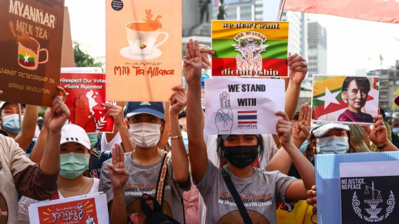 Demonstrators in Myanmar bring Milk Tea Alliance posters to their protest.